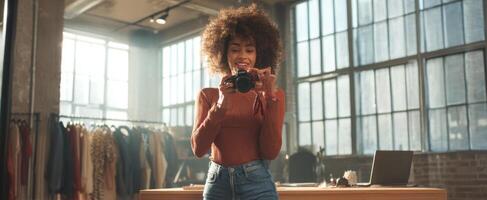 The young woman posing confidently with a camera in a stylish studio setting. photo