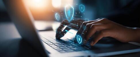 The hands typing on a laptop with digital security icons representing protection. photo