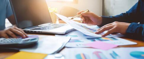 The collaborative effort in a modern professional workspace with documents and technology. photo