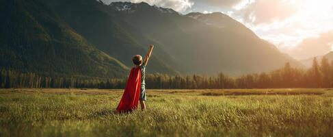 The child in a superhero cape embracing adventure in a stunning landscape. photo
