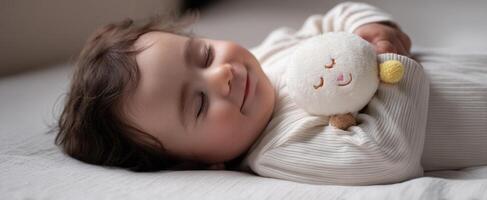 The adorable baby peacefully sleeping with a plush toy for comfort photo
