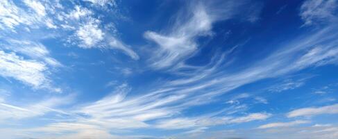 The beautiful blue sky adorned with wispy, delicate clouds. photo