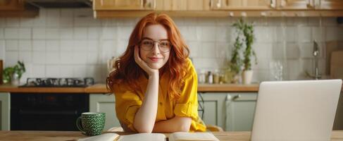 The cheerful woman enjoying coffee while working in a cozy kitchen. photo