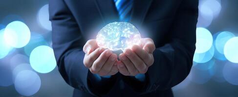 The businessman holds a glowing brain representing innovative ideas and technology. photo