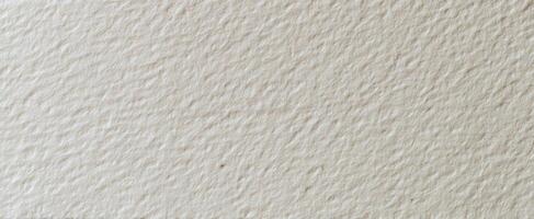 The textured surface of handmade paper in muted cream shades. photo