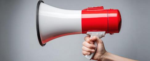 The vibrant megaphone held in hand for making impactful announcements. photo