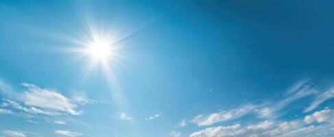 The Bright Sun Shining Over a Clear Blue Sky with Fluffy Clouds photo
