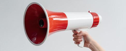 The megaphone held in hand for powerful public communication and announcements photo