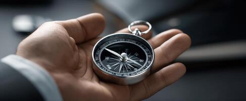 The stylish compass held in a hand symbolizing direction and exploration. photo