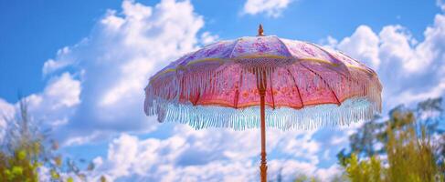 The decorative umbrella casting shade under a bright summer sky. photo