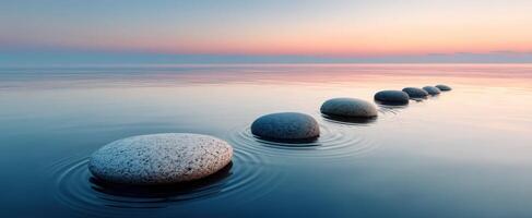 The serene journey of stones across calm water at sunset photo