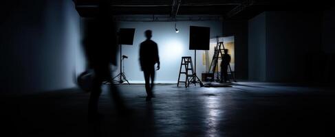 The silhouettes of people moving within a creative art studio space photo