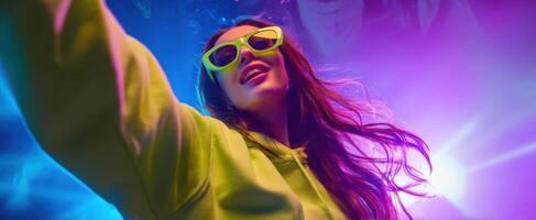 The vibrant young woman enjoying a lively party atmosphere with neon sunglasses. photo