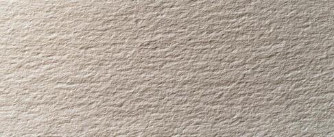 The subtle texture of beige handmade paper surface for creative backgrounds photo