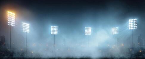 The illuminated sports stadium glowing under a mysterious fog at night. photo
