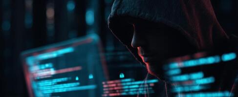 The mysterious hacker working on advanced coding in a dark environment. photo