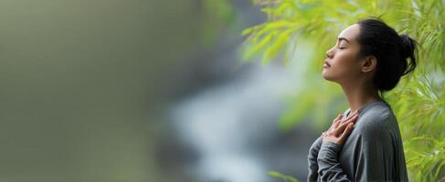 The woman finding peace in nature through mindfulness and meditation. photo