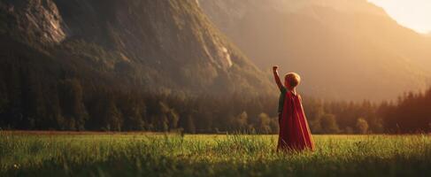 The child in a superhero cape embracing nature and dreams at sunset. photo