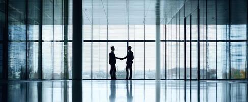 The handshake symbolizing a successful business partnership in a modern office space. photo