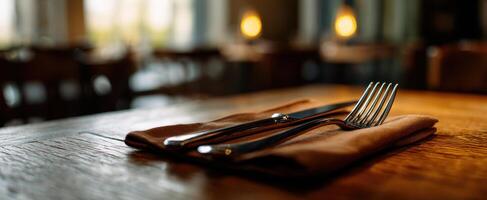 The elegant arrangement of cutlery on a rustic wooden table. photo