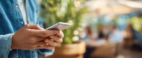 The person using a smartphone in a vibrant outdoor setting. photo