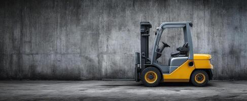 The detailed forklift parked against a textured concrete wall. photo