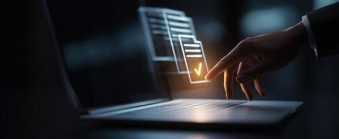 The hand interacting with a digital approval interface on a laptop. photo