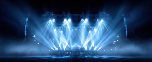 The spectacular stage illuminated by dynamic blue lighting in a concert setting. photo