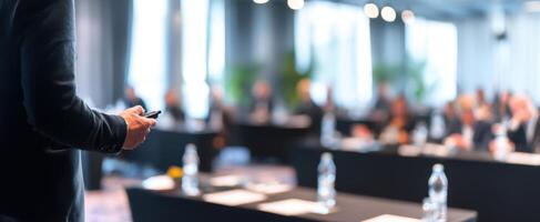 The speaker captivating the audience during a corporate conference presentation. photo