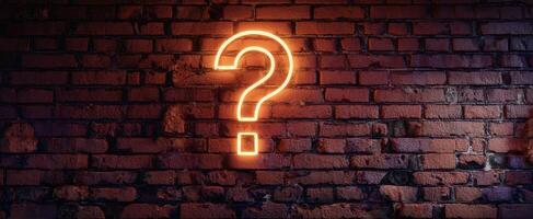 The glowing question mark illuminating a textured brick wall background. photo