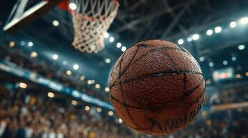 Basketball in motion during an exciting game with fans cheering in the background under bright arena lights photo