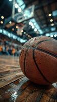 Basketball resting on the court during an exciting game at a packed arena in the evening photo