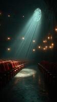Light beams illuminate the empty theater with red velvet seats during early evening hours photo