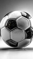 Classic black and white soccer ball resting on a smooth surface with a minimalist backdrop photo