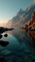 Majestic mountains reflected in a tranquil lake during golden hour in a serene landscape photo