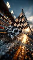 Racing flag waves during a sunset at a motorsport event with blurred crowd in the background photo