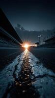 Beautiful sunset over a racetrack with cracked asphalt and illuminated grandstands in the background photo