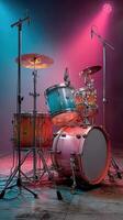 Colorful drum set illuminated by stage lights during a music performance photo