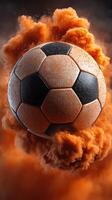 Soccer ball surrounded by an explosion of orange dust in a dynamic sports moment photo