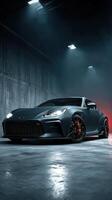 Sleek sports car parked in a dimly lit garage with dramatic lighting at night photo
