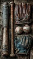 Vintage baseball equipment arranged on a wooden surface showing bats and gloves ready for play photo