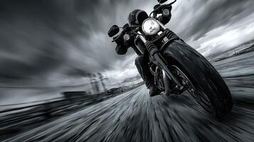 Motorcyclist riding swiftly on an open road under dramatic skies at dusk photo