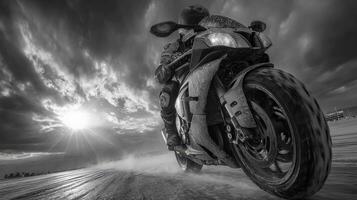 Motorcycle rider speeding down a dirt path during sunset with dramatic skies ahead photo