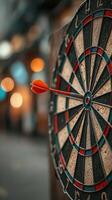 Dart hitting the bullseye on a vintage dartboard in a lively pub atmosphere during the evening photo