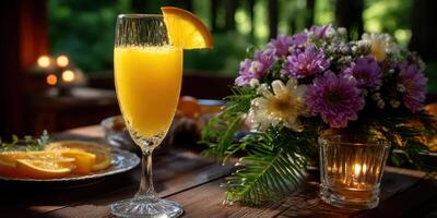 Refreshing citrus drink served in a tall glass beside a vibrant flower arrangement during a sunny afternoon gathering photo