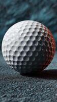 Close-up view of a textured golf ball resting on a dark surface with soft lighting highlighting its dimples and contours photo