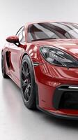 Sleek red sports car showcased indoors with polished surface and modern lighting photo
