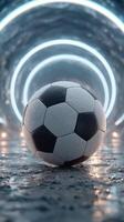 Soccer ball resting on wet surface in illuminated tunnel during late evening or night photo