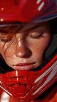 Close-up of a young woman in a red helmet, preparing for a thrilling motocross adventure on a sunny day photo