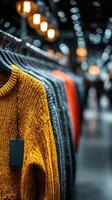 Colorful sweaters arranged attractively in a modern retail store during evening shopping hours photo